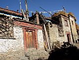 08 People On The Roofs Of Houses In Nar Village Stacked With Hay And Cows Down Below 